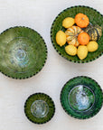Authentic Tamegroute pottery bowl, handmade in the village of Tamegroute, southern Morocco. Every bowl is hand-thrown from local mineral-rich clay and finished with the village's signature deep green glaze. Fired in underground wood-fired kilns using centuries-old techniques, the heat creates natural variations in tone and texture across each piece. The glaze reacts organically to the kiln fire, producing distinctive emerald-to-moss tones with subtle bronze highlights. No two bowls are identical.
Perfect as
