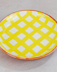 Yellow and white checkered plate on a light gray background