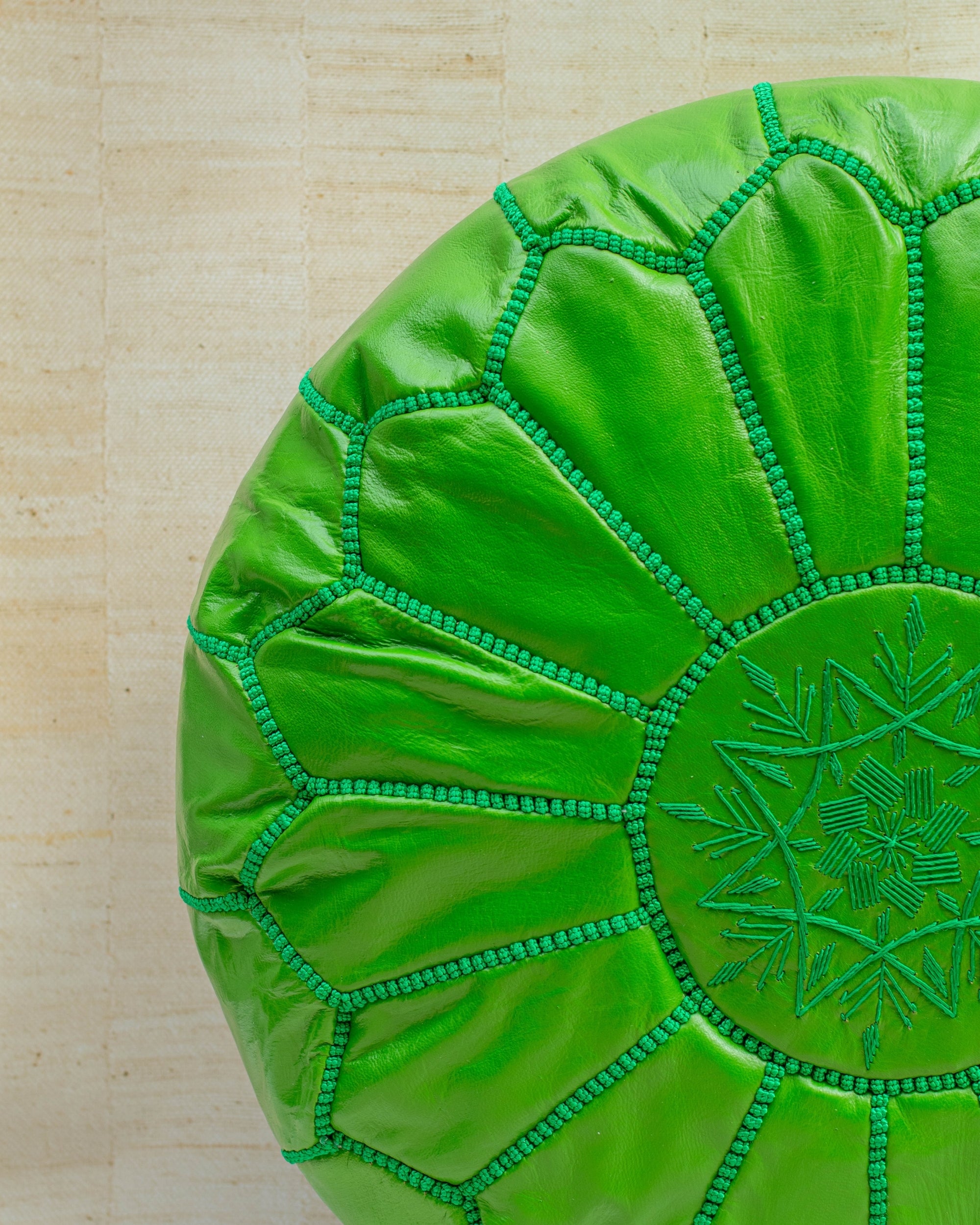 Apple green leather pouf – hand-stitch detail close-up