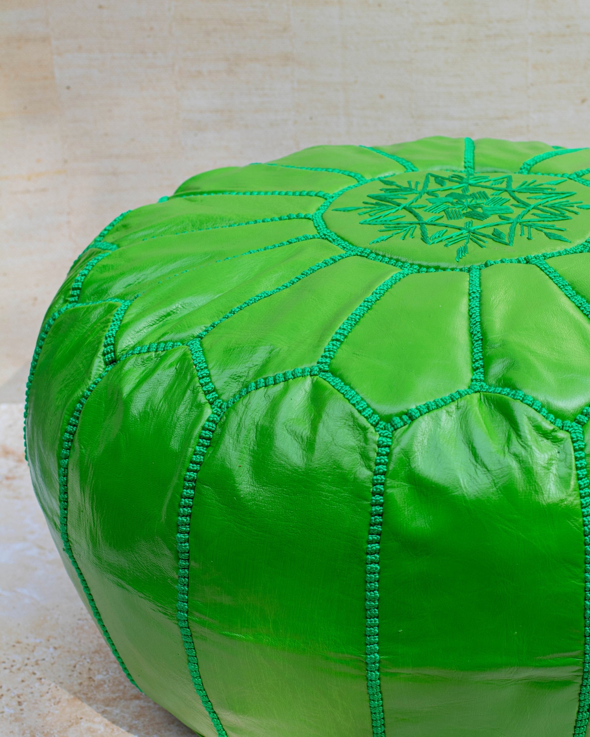 Apple green pouf styled as ottoman in living room