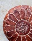 Brown leather pouf – close-up of hand stitching