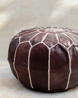 Chocolate leather pouf styled in living room