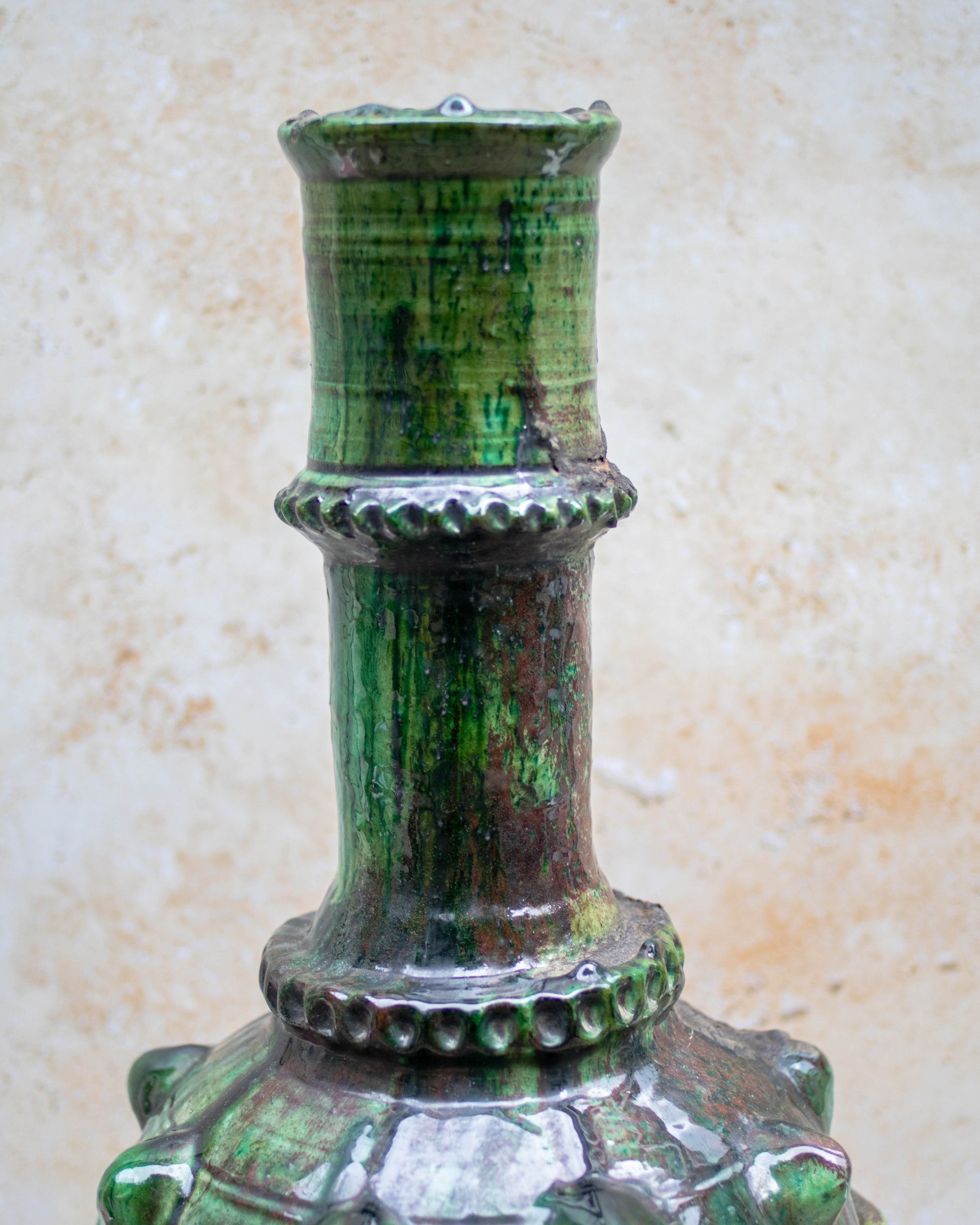 Close-up of glossy green glaze and raised detailing on Tamegroute vase