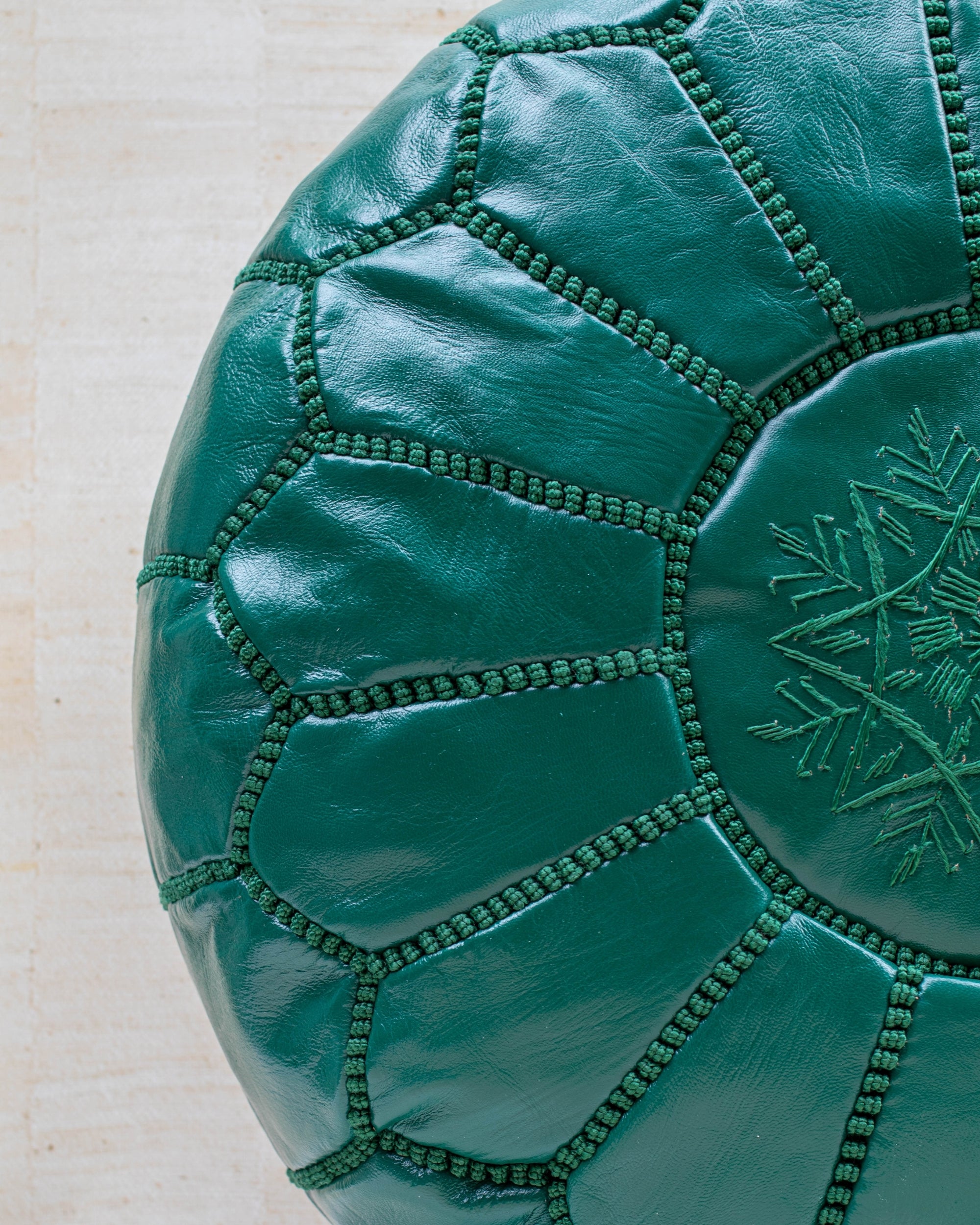Emerald green leather pouf – hand-stitch detail close-up
