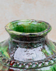 Green ceramic vase with bronze accents and hand-carved detailing