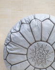 Grey leather pouf with hand-stitching – embroidery detail close-up