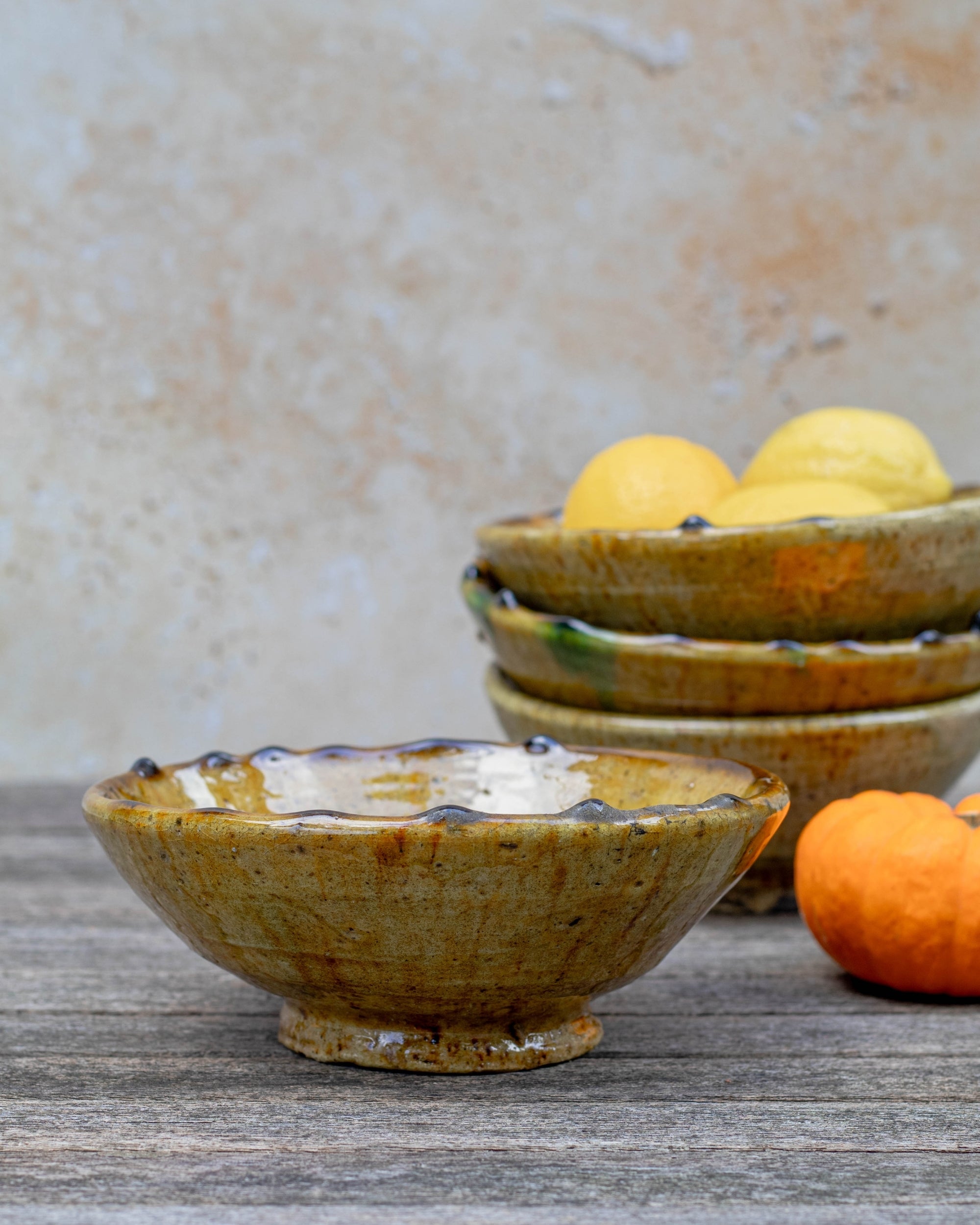 Handmade Tamegroute ochre serving bowl styled with lemons
