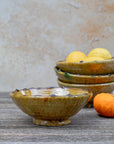 Handmade Tamegroute ochre serving bowl styled with lemons