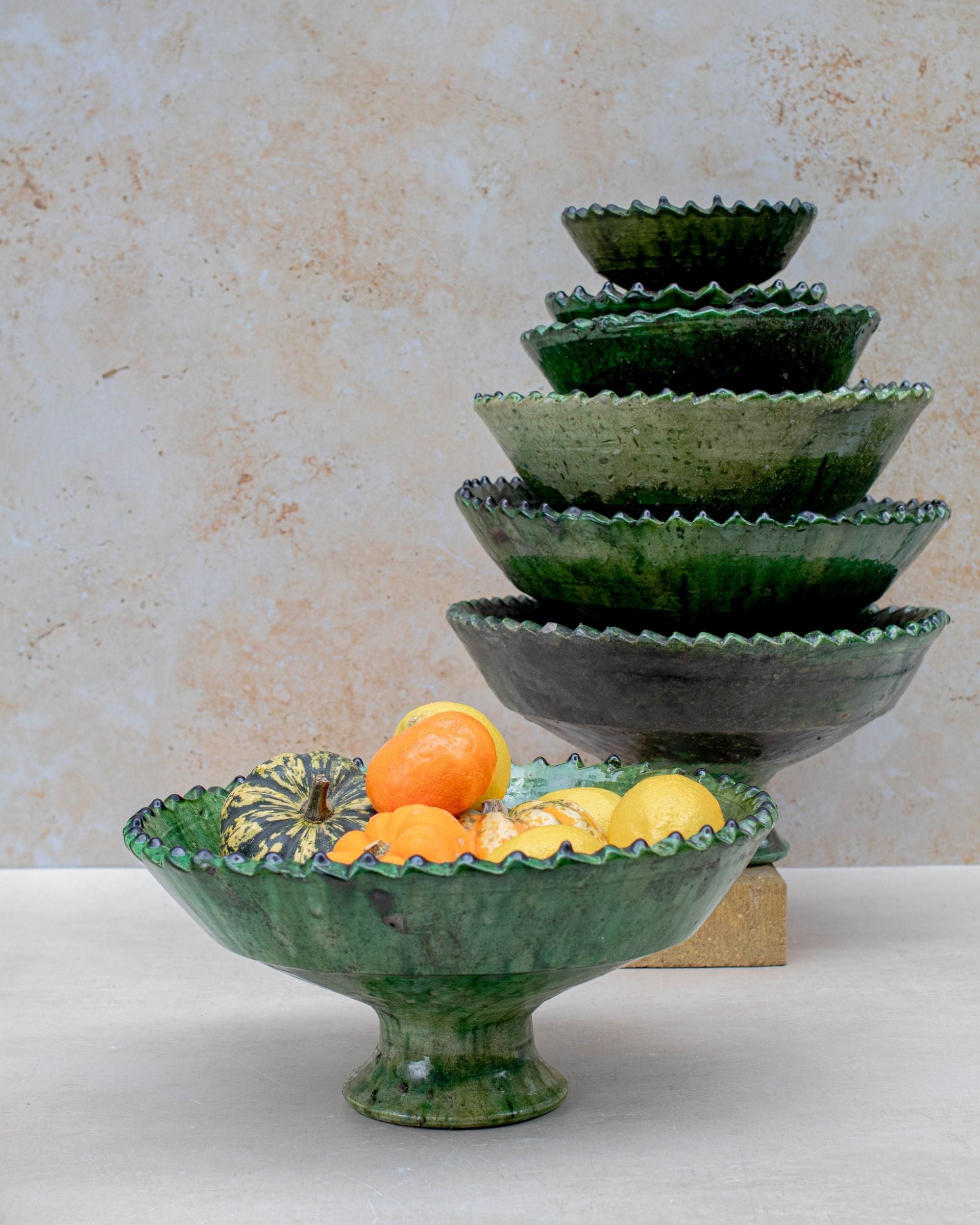 Large green bowl used as fruit bowl on wooden table