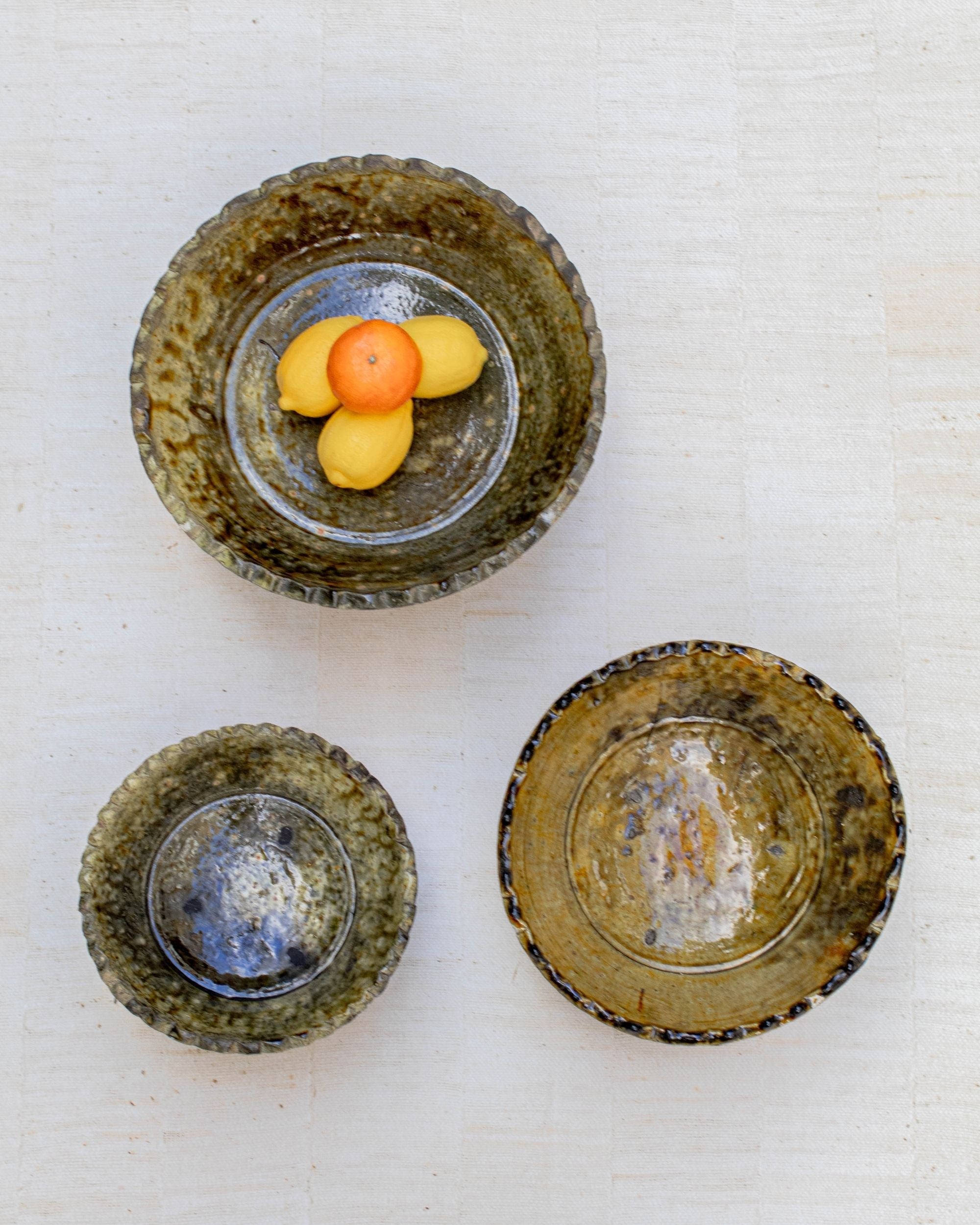 Large ochre bowl used as fruit bowl on kitchen island