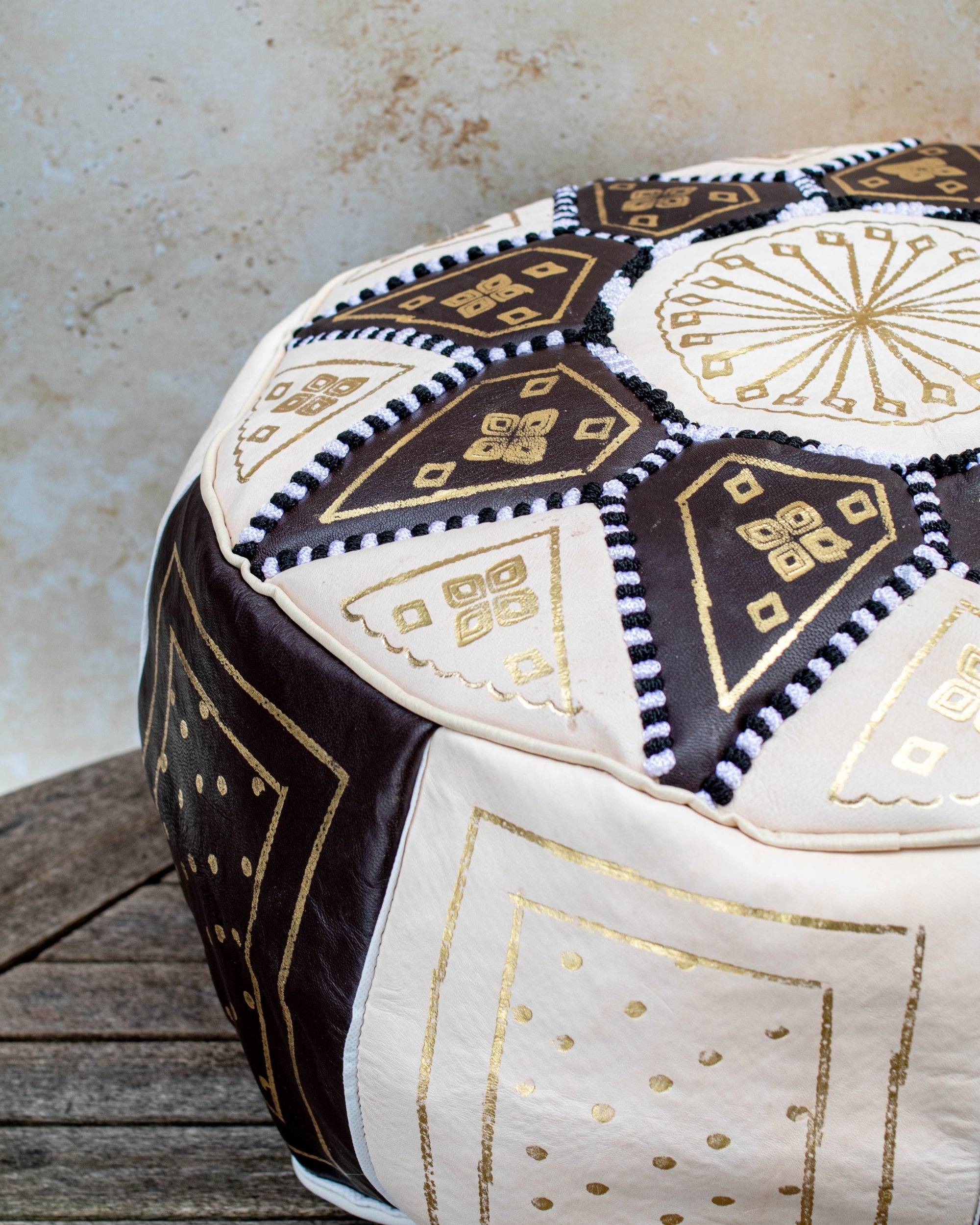 Moroccan leather pouf styled as ottoman in living room