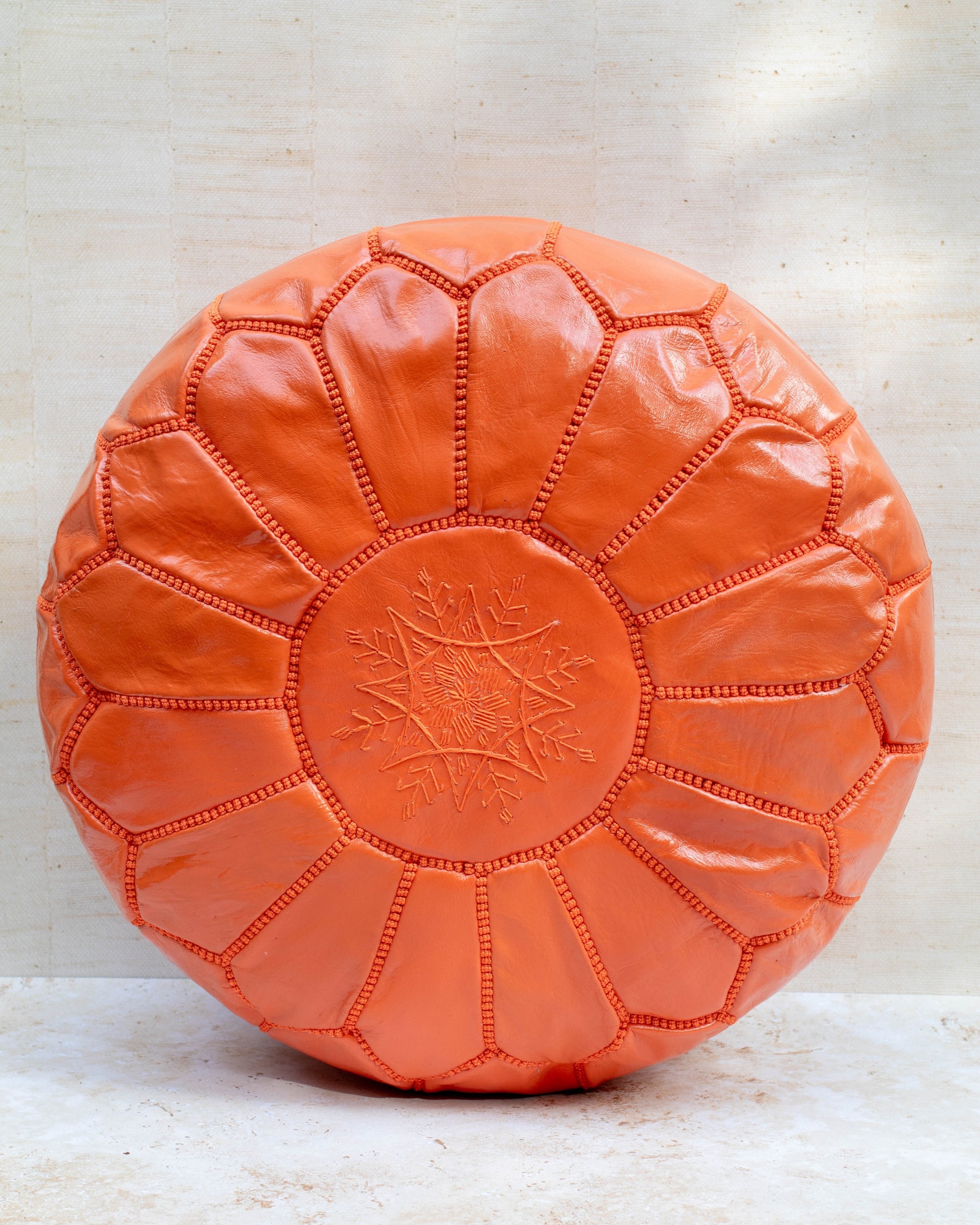 Moroccan leather pouf – orange, front view