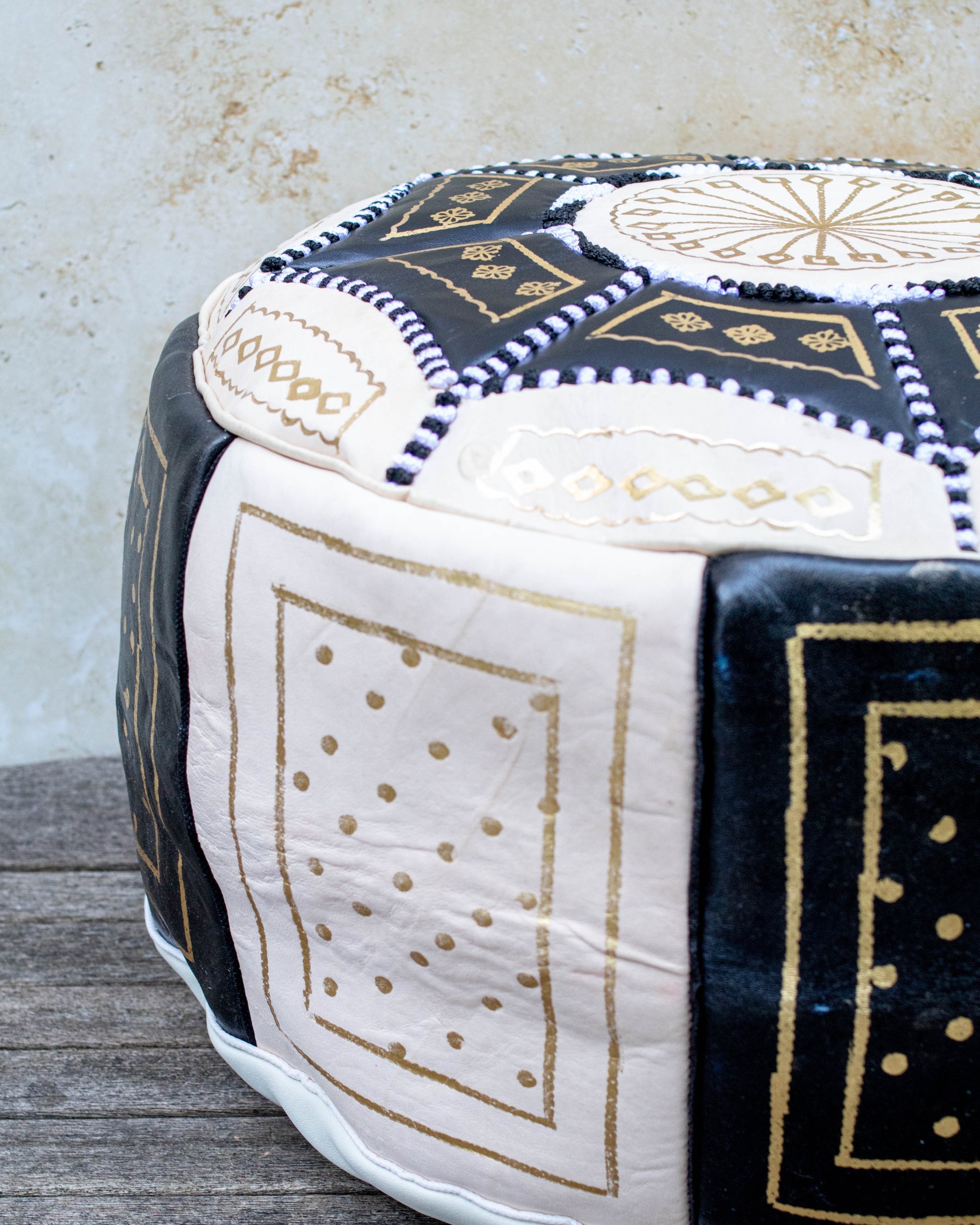 Moroccan leather pouf styled as ottoman in living room