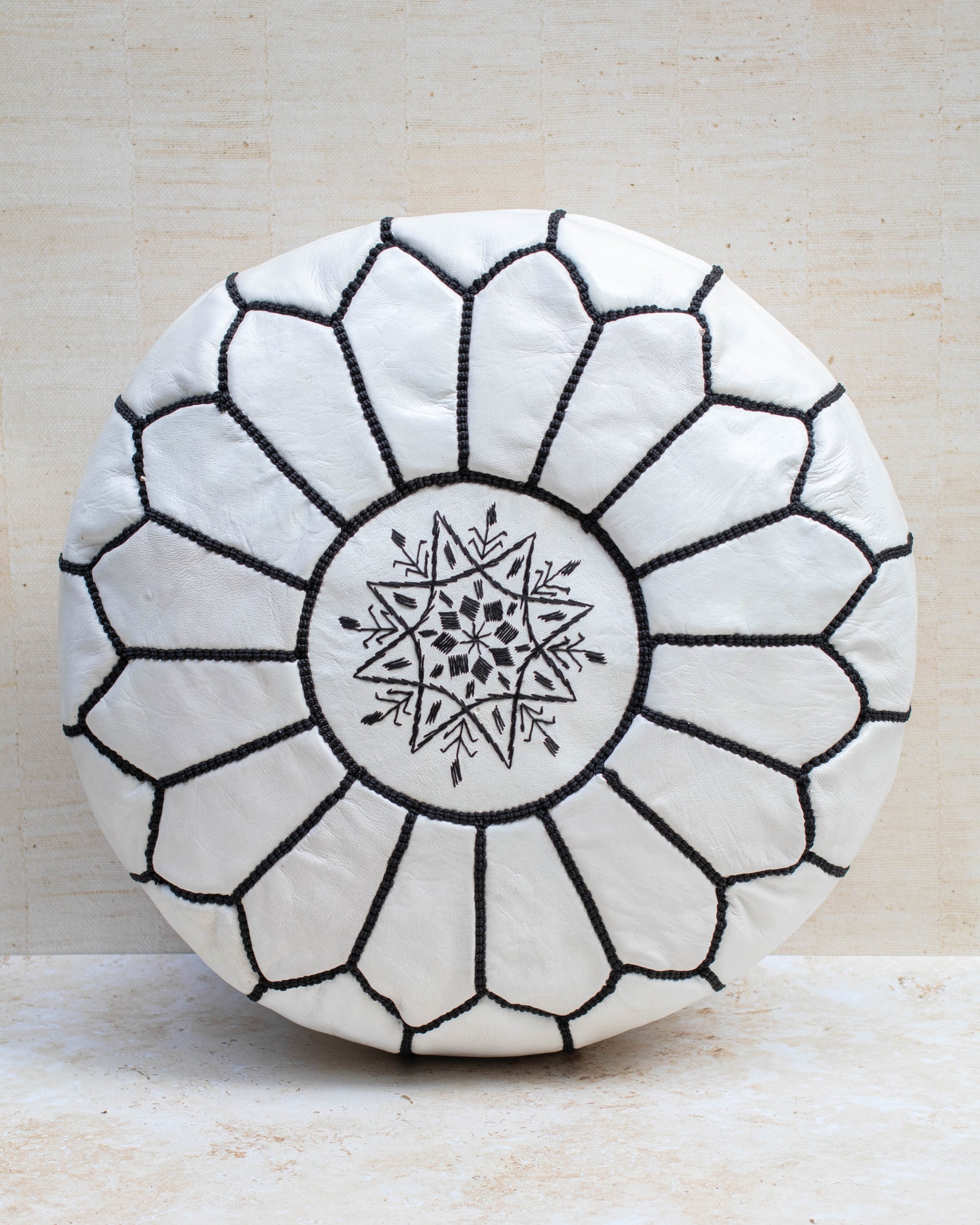 Moroccan leather pouf – white with black stitching, front view