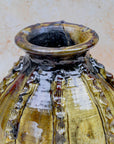 Moroccan pottery vase with ribbed relief and amber tones