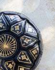 Moroccan leather pouf styled as ottoman in living room
