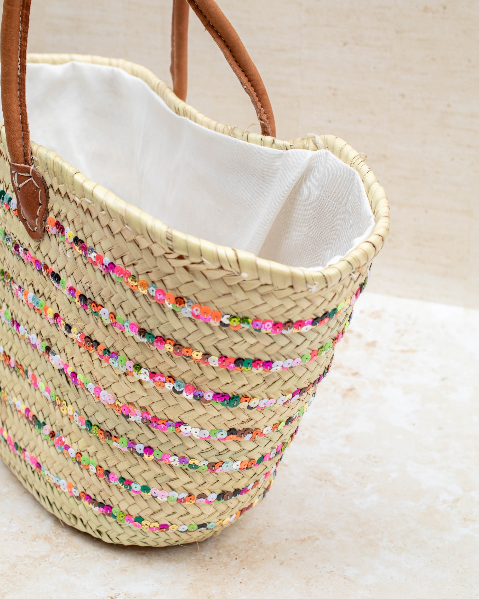 Multicoloured embroidered basket styled for summer shopping