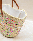 Multicoloured embroidered basket styled for summer shopping