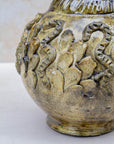 Ochre ceramic vase with amber and bronze tones