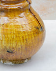 Ochre ceramic vase with amber and honey tones