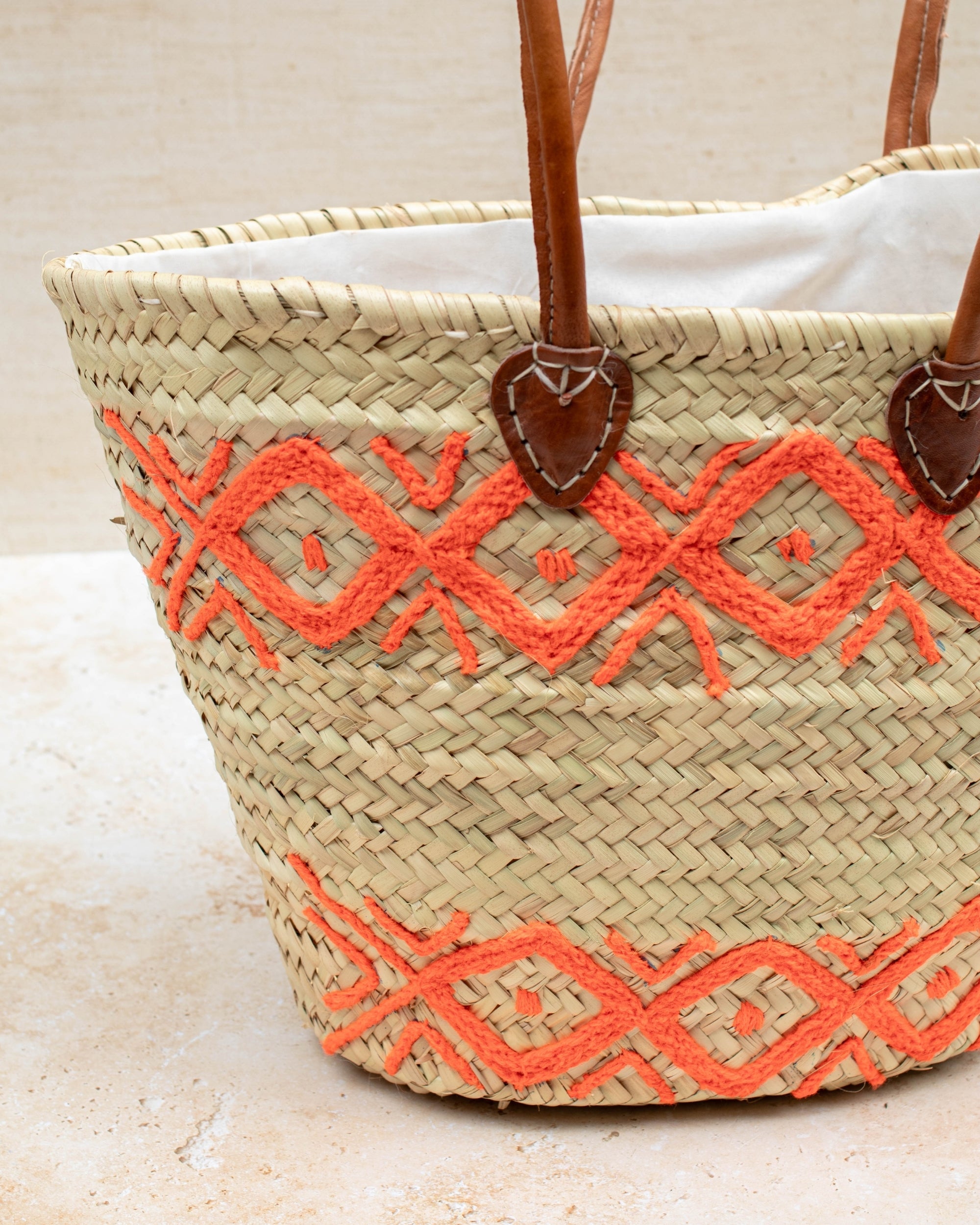 Orange embroidered palm leaf basket – close-up of stitching