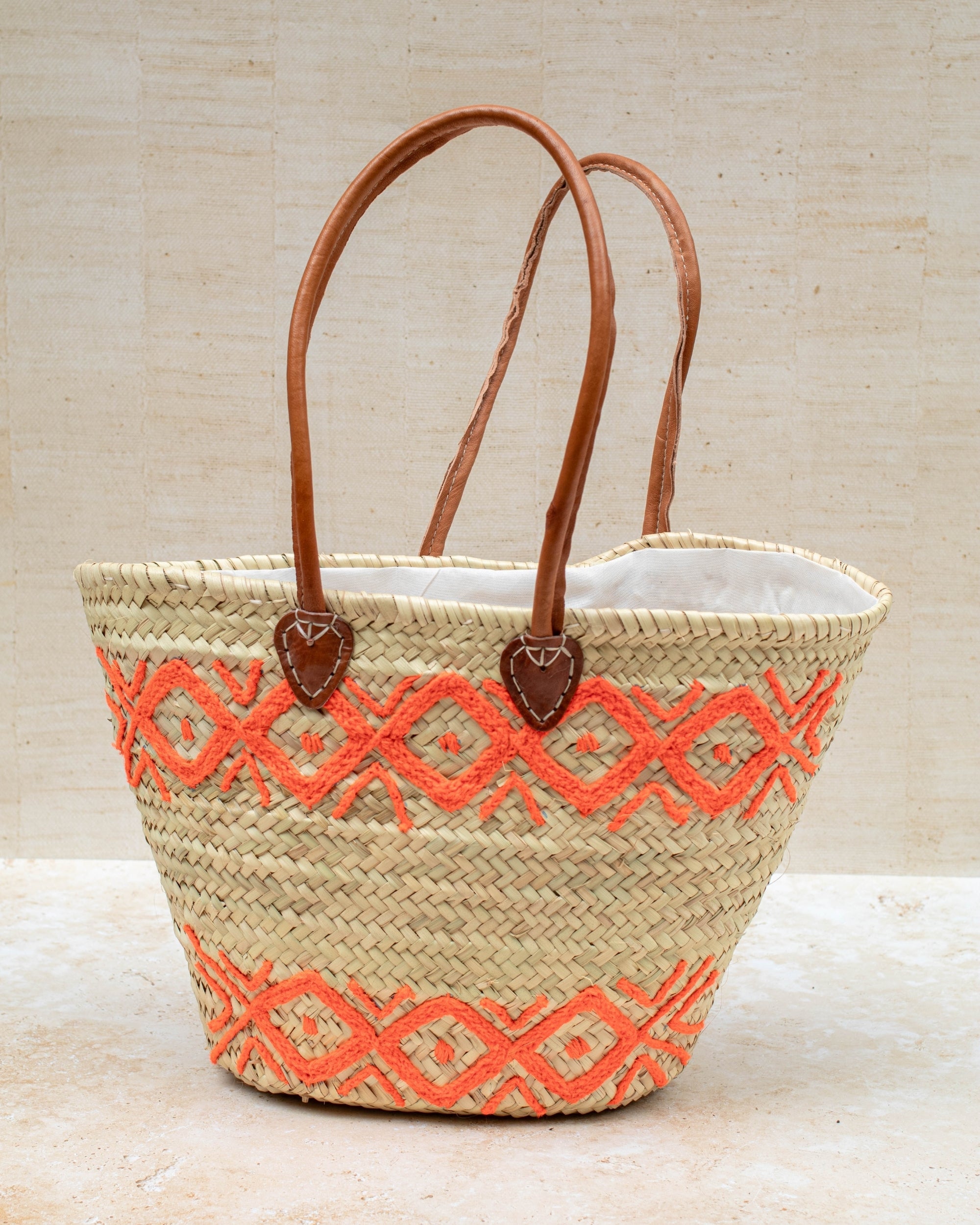 Orange embroidery basket styled for summer shopping