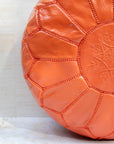 Orange leather pouf with hand-stitching – embroidery detail close-up