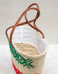 Palm leaf basket with green and red embroidery – close-up of stitching