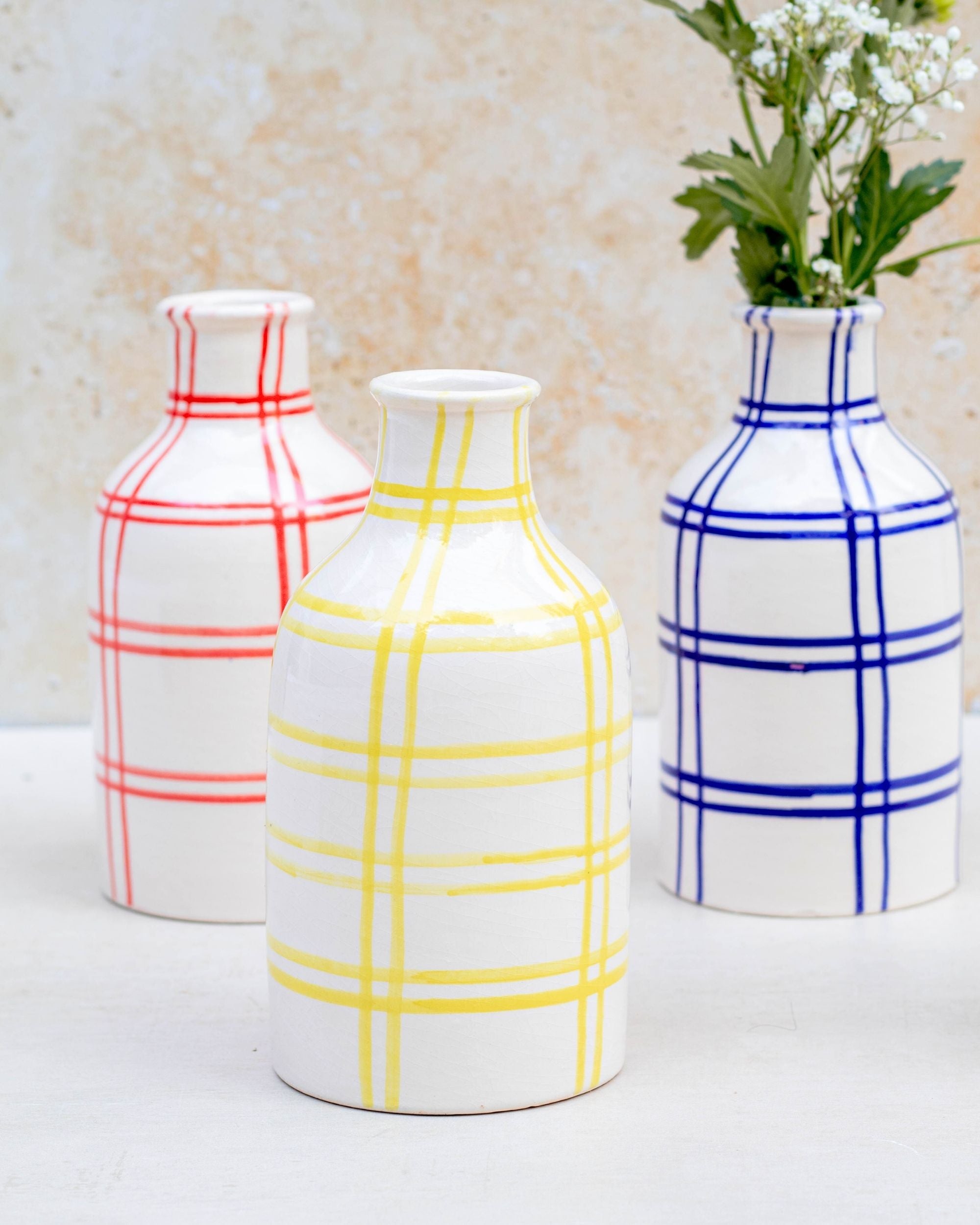 Red checkered vase with flowers