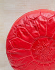 Red leather pouf – hand-stitch embroidery close-up