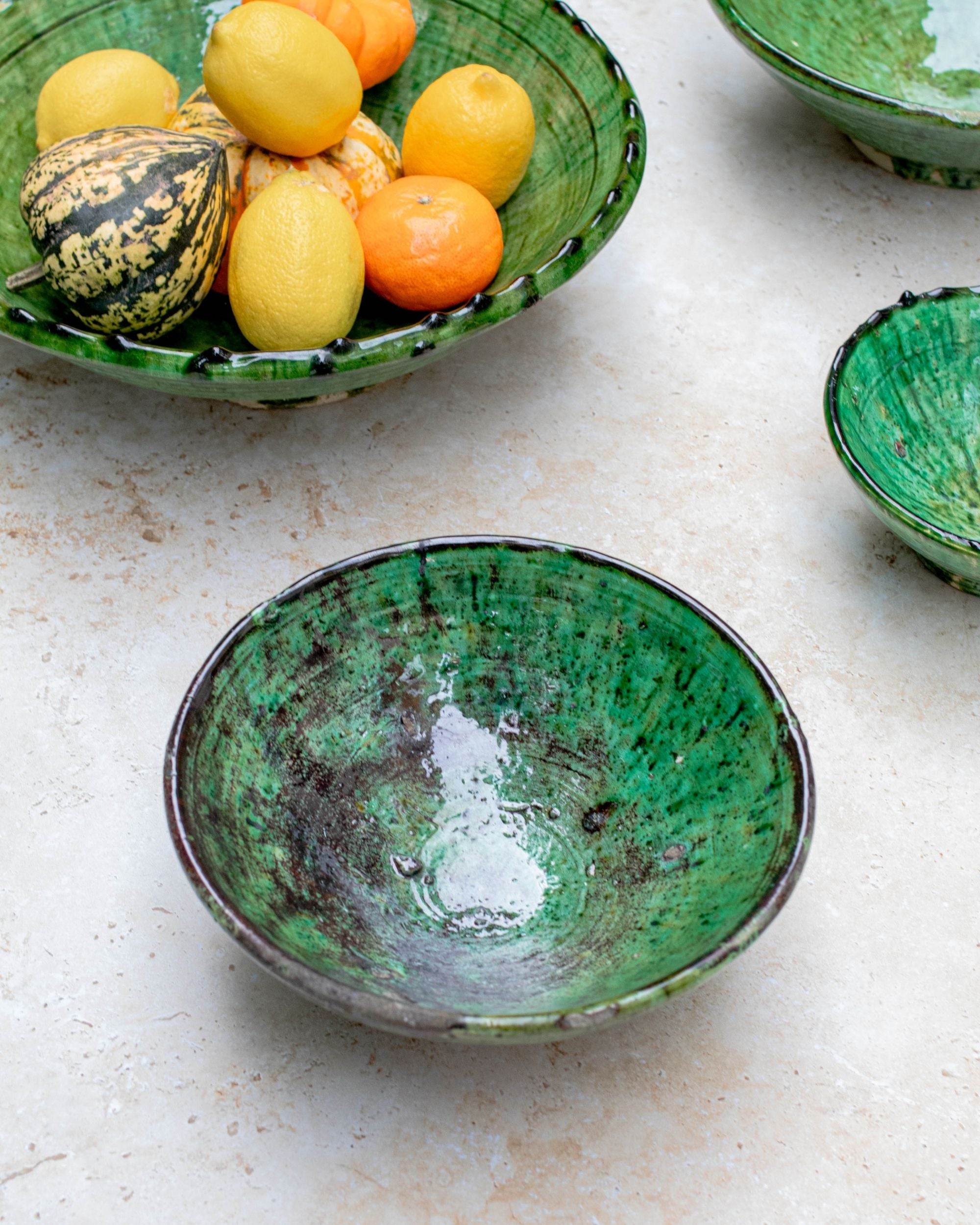 Side profile of green ceramic bowl with natural finish