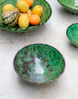 Side profile of green ceramic bowl with natural finish