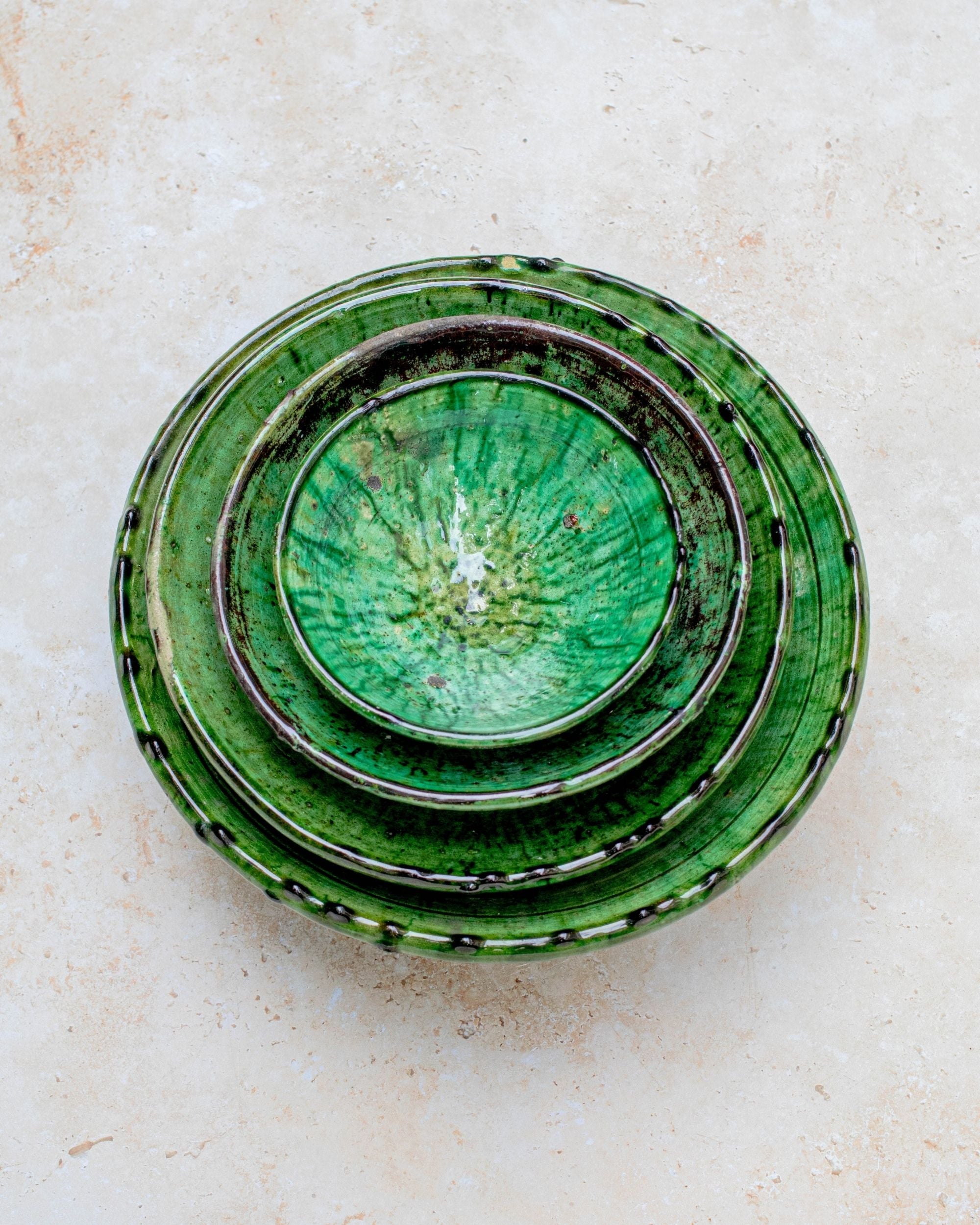 Stacked Tamegroute green bowls showing handmade glaze variations