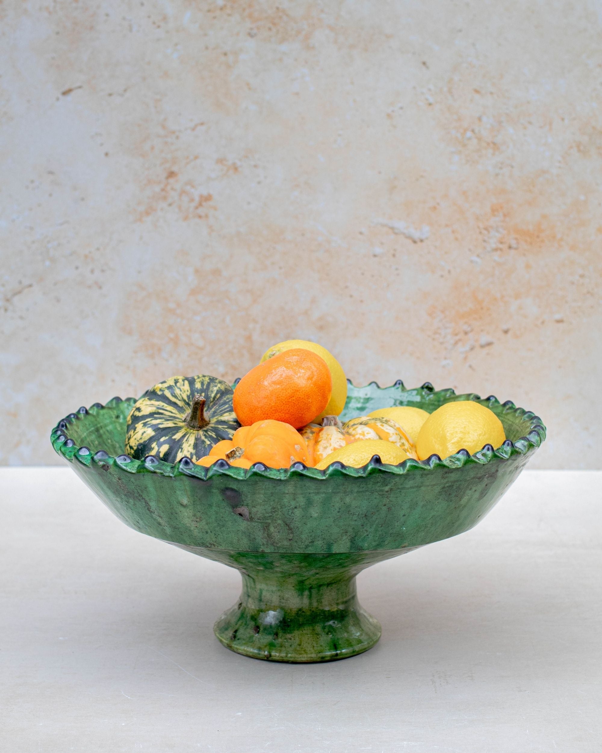 Stacked Tamegroute green pedestal bowls showing handmade glaze variations