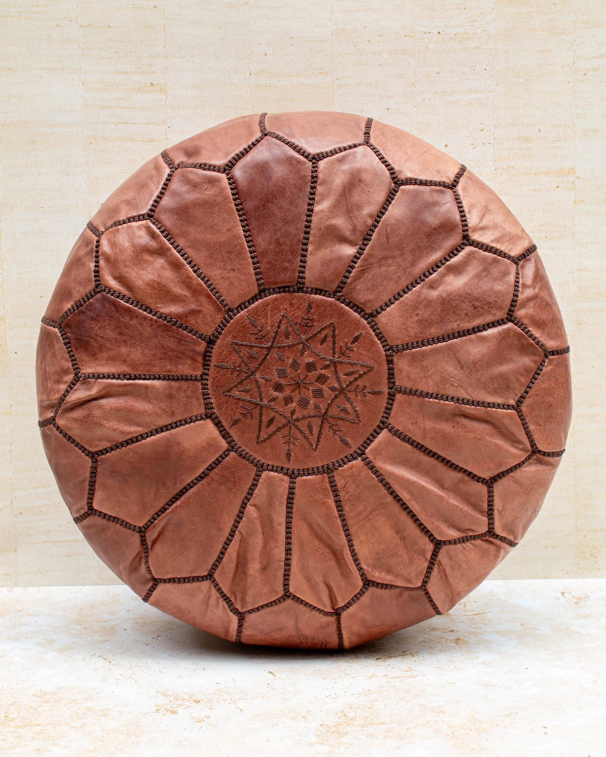 Tan Moroccan leather pouf — front view