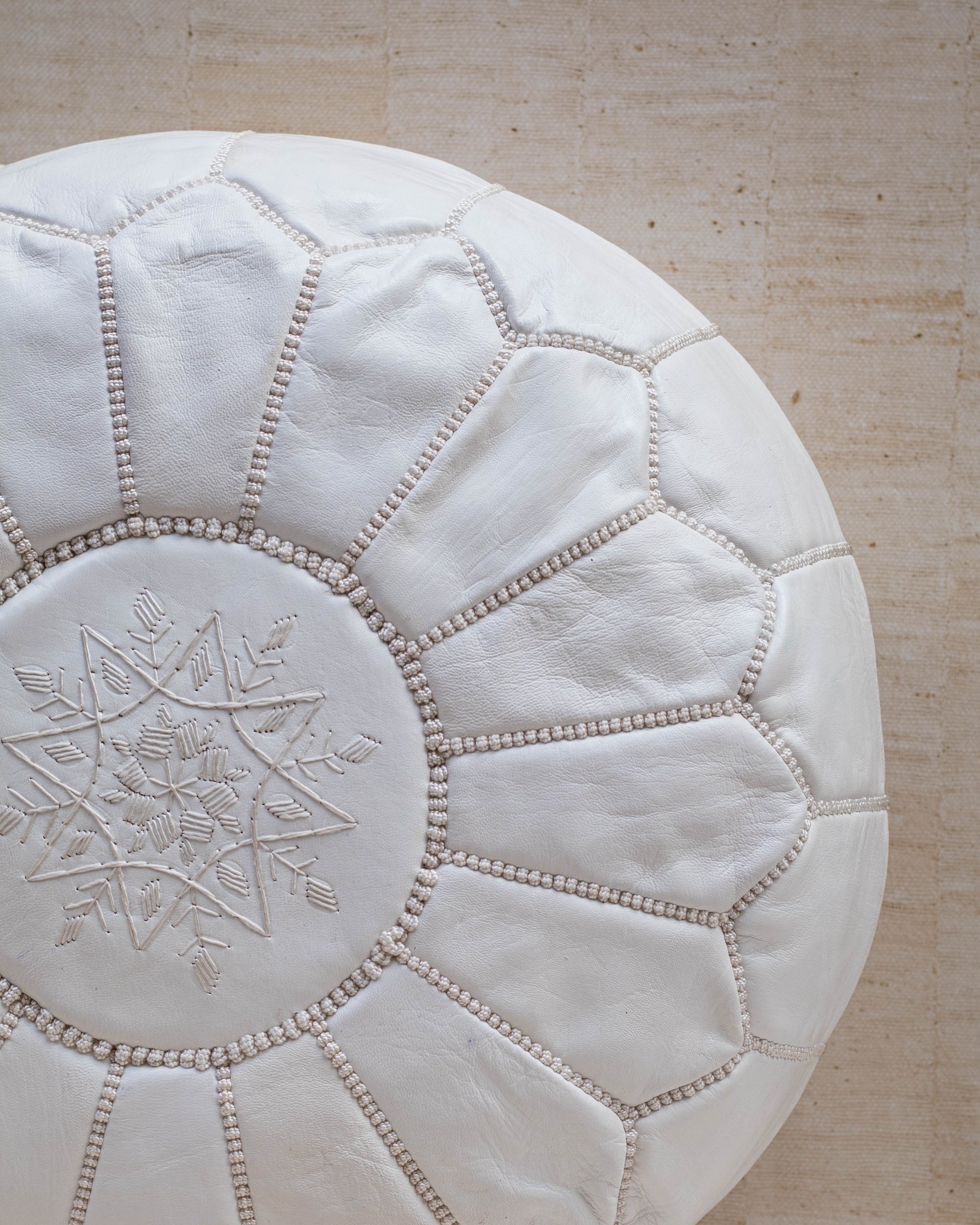 White leather pouf – close up of stitching
