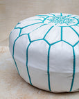 White leather pouf with turquoise hand-stitching – embroidery detail close-up