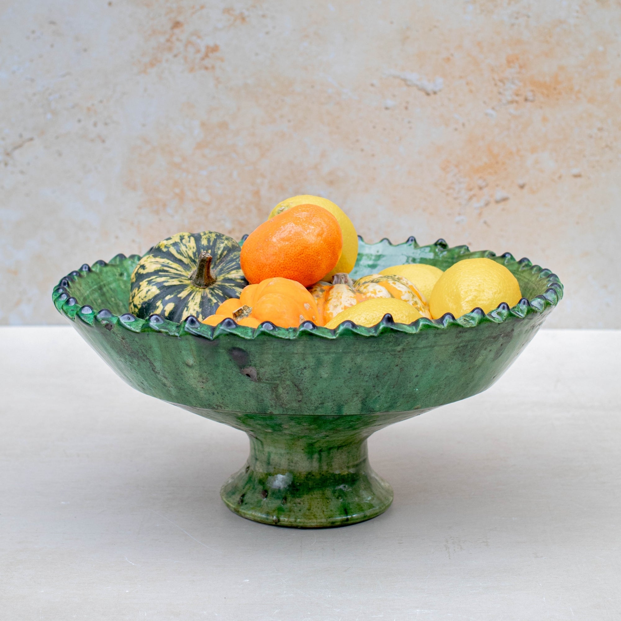 Authentic Tamegroute pottery bowl, handmade in the village of Tamegroute, southern Morocco. Every bowl is hand-thrown from local mineral-rich clay and finished with the village's signature deep green glaze. Fired in underground wood-fired kilns using centuries-old techniques, the heat creates natural variations in tone and texture across each piece. The glaze reacts organically to the kiln fire, producing distinctive emerald-to-moss tones with subtle bronze highlights. No two bowls are identical.
Perfect as