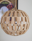 Elevate your space with our Bohemian Doum Suspension Rattan Lampshade. Handcrafted in Morocco from natural straw, this pendant light exudes authentic charm and warmth. Its intricate design allows for a soft, inviting glow, perfect for creating a cozy ambiance in any room. Bring a touch of Moroccan craftsmanship to your decor with this unique piece.