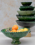 Authentic Tamegroute pottery bowl, handmade in the village of Tamegroute, southern Morocco. Every bowl is hand-thrown from local mineral-rich clay and finished with the village's signature deep green glaze. Fired in underground wood-fired kilns using centuries-old techniques, the heat creates natural variations in tone and texture across each piece. The glaze reacts organically to the kiln fire, producing distinctive emerald-to-moss tones with subtle bronze highlights. No two bowls are identical.
Perfect as