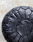 Black leather pouf – close-up of hand stitching