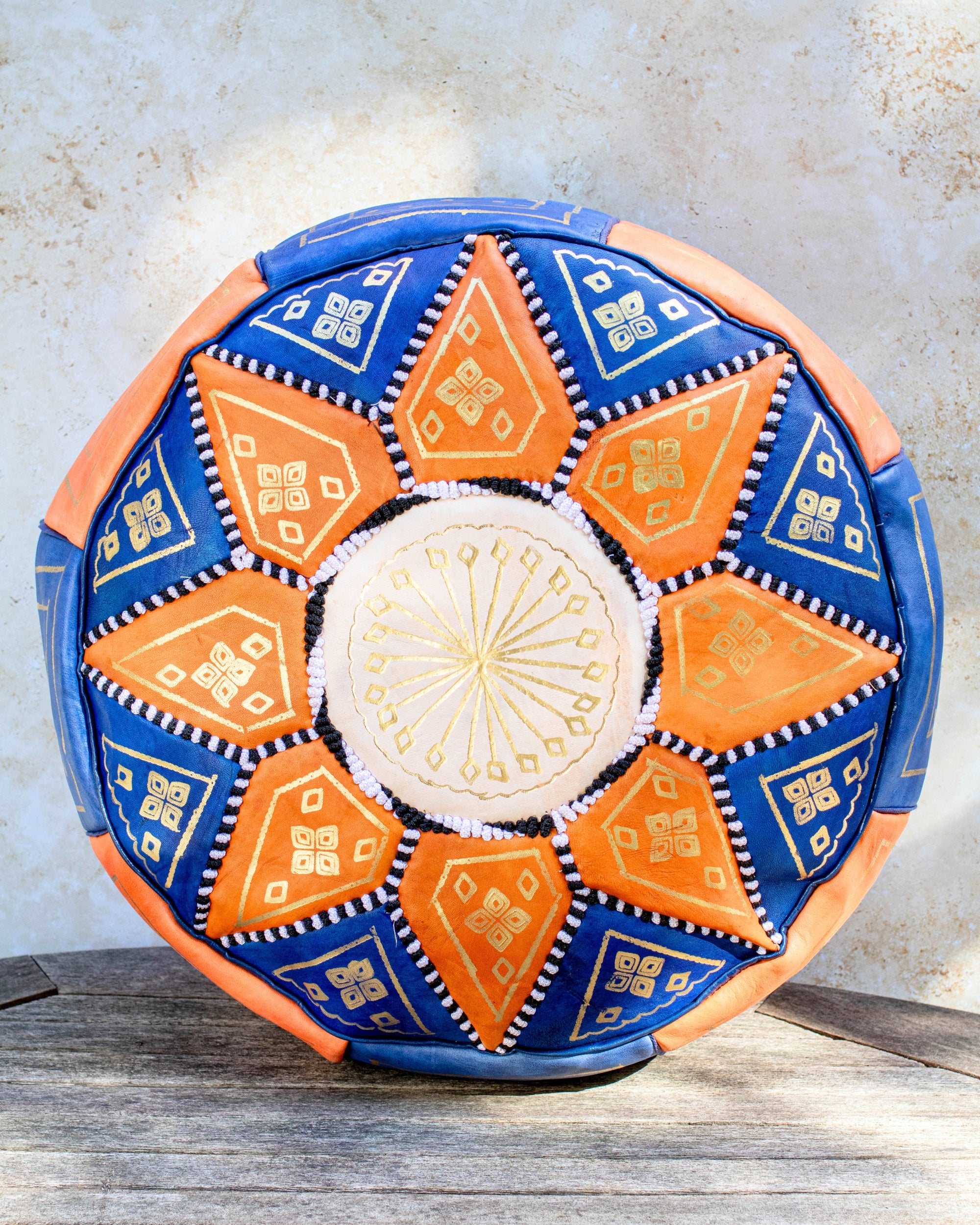 Blue and orange Moroccan leather pouf with gold embroidery front view