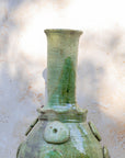 Close-up of raised circular detailing on pale green Moroccan pottery vase