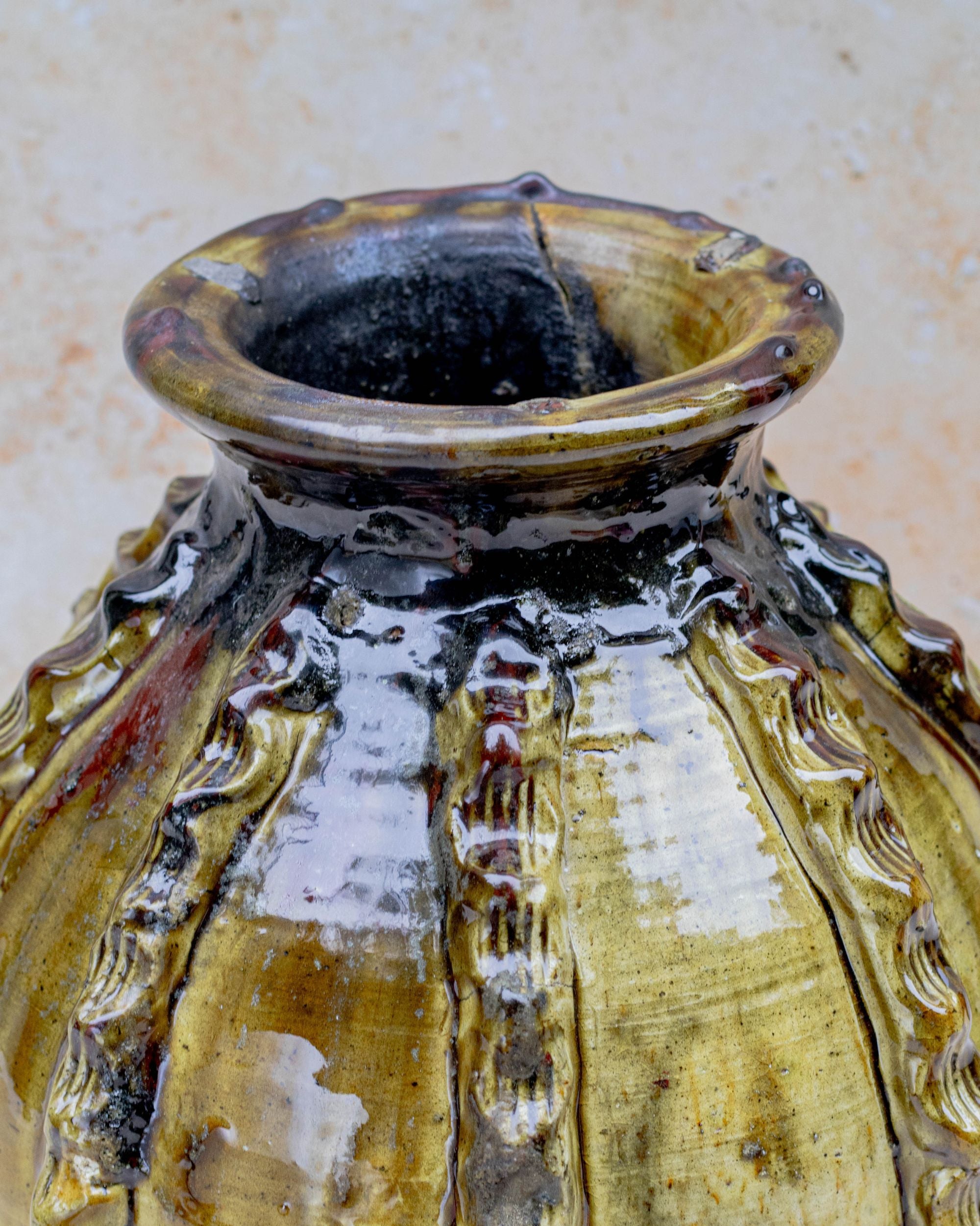 Moroccan pottery vase with ribbed relief and amber tones