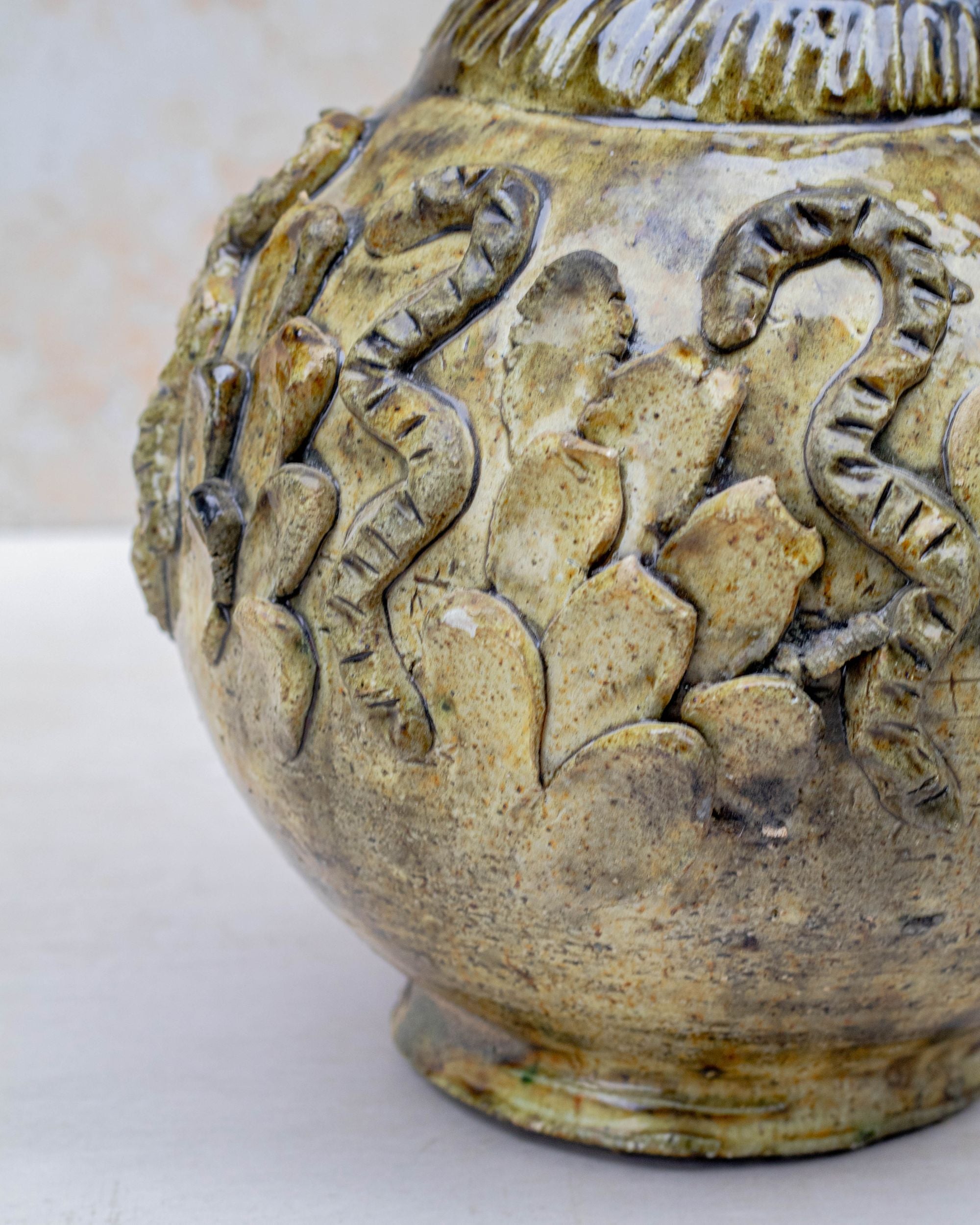 Ochre ceramic vase with amber and bronze tones