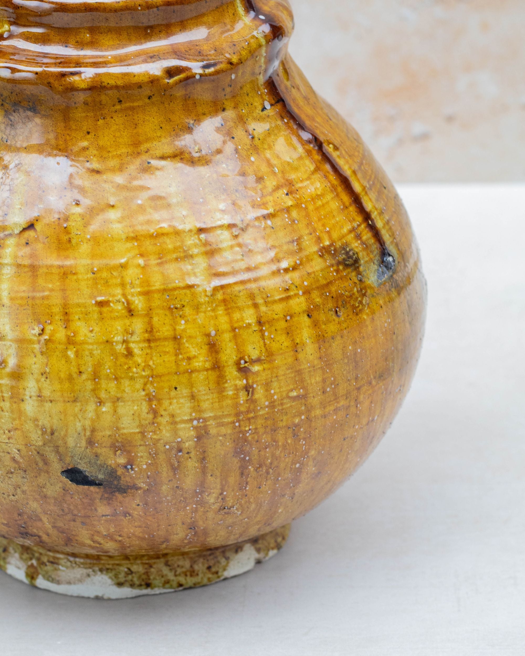 Ochre ceramic vase with amber and honey tones
