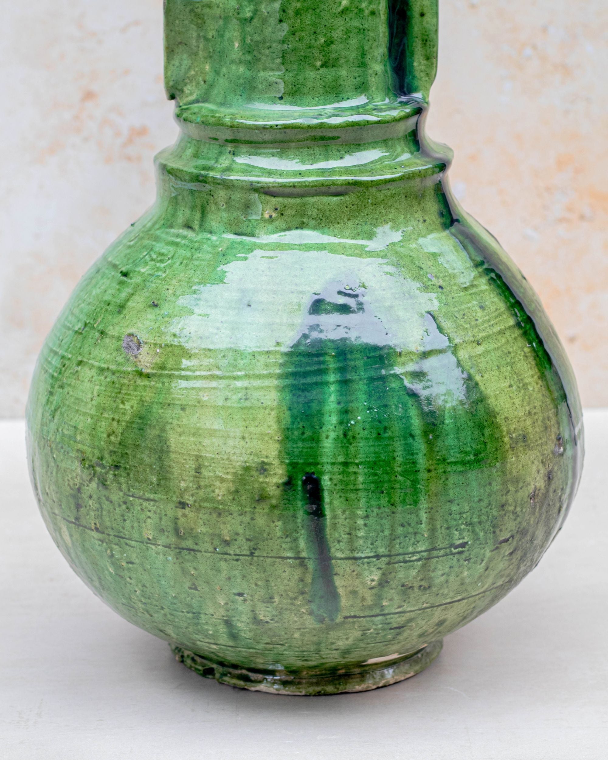 Sculptural green pottery vase with rounded base