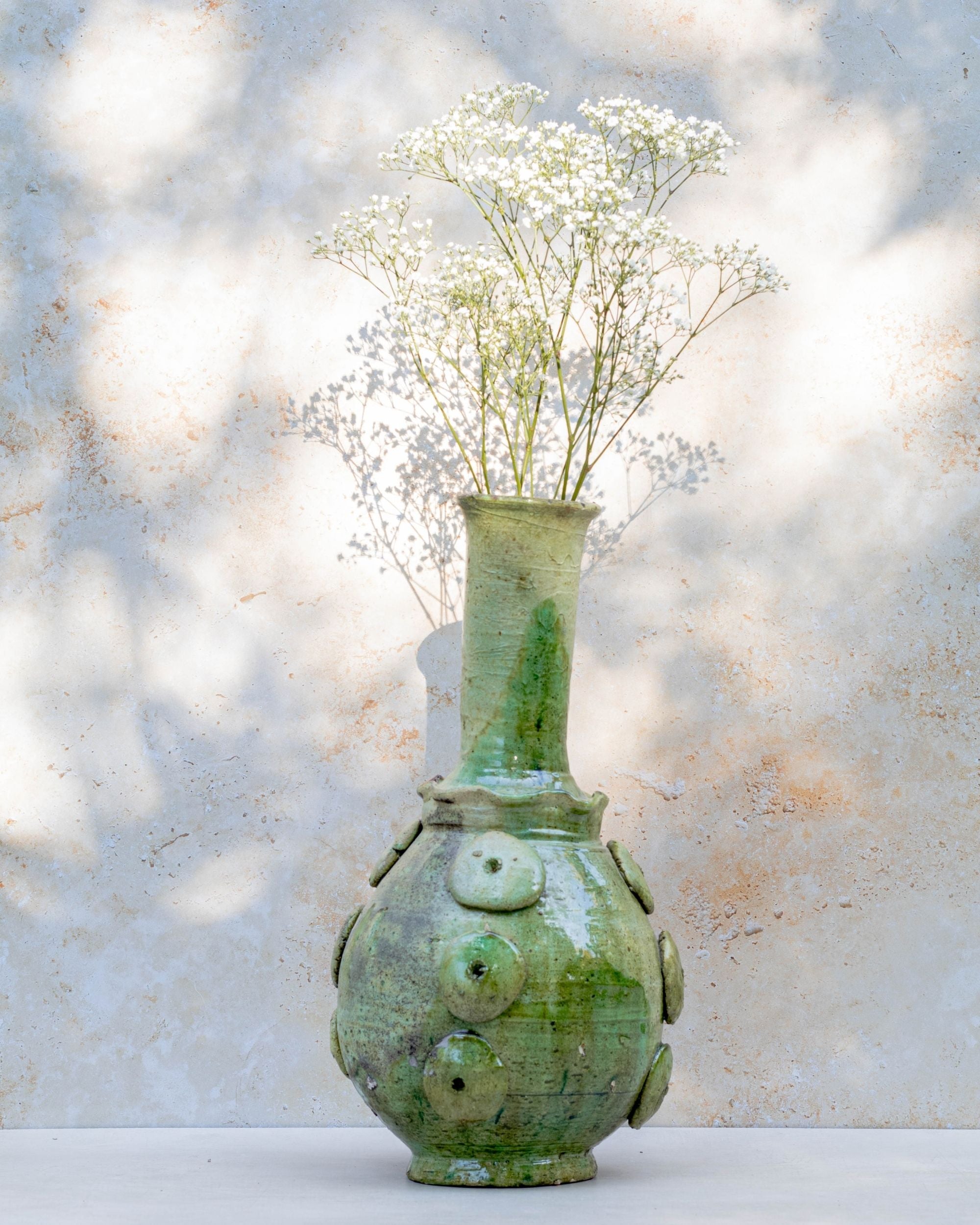 Tall Moroccan earthenware vase in pale green with glossy glaze finish