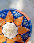Moroccan leather pouf styled as ottoman in living room
